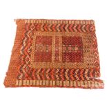 A Turkoman type rug, with a geometric design in navy blue, red, etc., on a red ground with