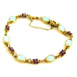 An amethyst and opal bracelet, set with a group of oval opals, and four point amethyst clusters,