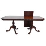 A mahogany two pillar dining table in George III style, the rectangular with rounded corners and a