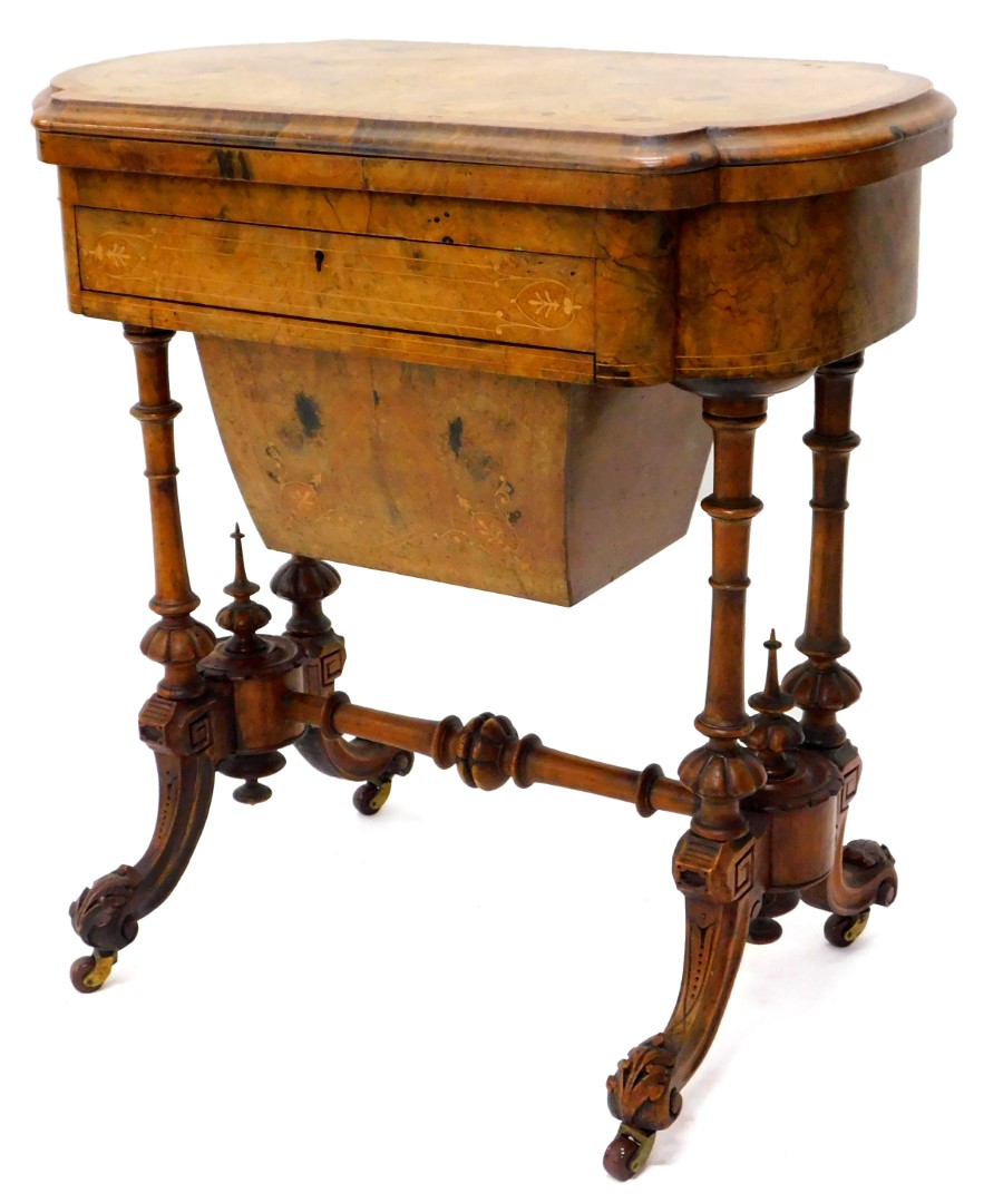 A Victorian walnut games/work table, the quarter veneered top with a burr yew crossbanded border and