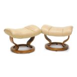 A pair of cream leather Stressless footstools. (AF)