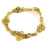 A 9ct gold charm bracelet, of thin design, with small heart shaped padlock, and safety chain, 18cm