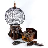 A carved Black Forest type cuckoo clock, with pine cone shaped weights, 30cm high, and a wire and