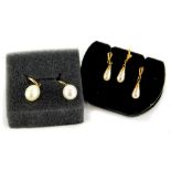 Two pairs of cultured pearl 9ct gold earrings, comprising a pair of modern curve design and single