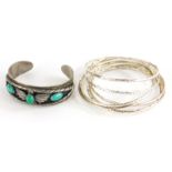 A group of bangles and bracelets, to include an eagle bangle, set with three turquoise stones, white