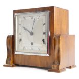 A walnut Art Deco mantel clock, with chrome plated bezel and Westminster chime, 26cm wide.