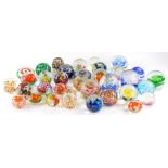 A large quantity of continental coloured paperweights, to include some millefiori, others with