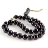 A garnet necklace, with graduated spherical beads, the largest 1cm wide, the smallest 8mm wide, on