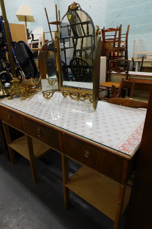 A mahogany pine and glass rectangular dressing table, with fabric top and a gilt triple mirror. (2)