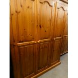 A pine triple wardrobe, with panelled doors, 199cm high, 155cm wide.