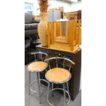 A small nest of oak tables, book case, a rattan vase and two chrome plated bar stools.