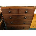 A Victorian oak and mahogany chest of two short and three long drawers, each with turned wood