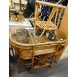 A bamboo small table with glass top, two matching chairs and a bamboo occasional table.