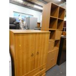 A pine effect cupboard and three oak effect units.