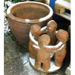 A red stoneware jardiniere, with ceramic feet, 50cm wide, and a garden ornament of four embracing