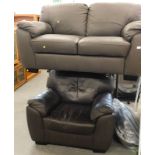 A two seater brown leatherette sofa, and a similar arm chair. The upholstery in this lot does not