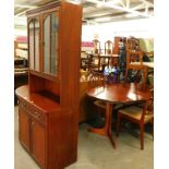 A mahogany room unit or display cabinet, an extending dining table, five chairs, one with arms.