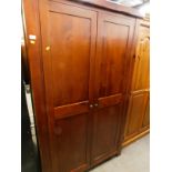 A cherrywood two door wardrobe, 195cm high, 118cm wide.