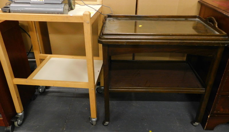 A walnut veneered tray top two tier trolley, and another trolley. (2)