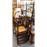 A wrought iron rectangular wall mirror, and two ladder back chairs.