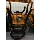 A pair of Victorian mahogany balloon back chairs, each with a green upholstered padded seat on