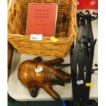 A treen figure of a recumbent pig, a wicker basket, plated wares, an expanding wall mounted