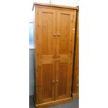 A pine cupboard with two pairs of doors, 198cm high, 81cm wide.