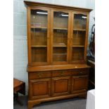 A Stag minstrel type mahogany display cabinet, with three glazed doors and three drawers and