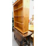 An oak drop leaf table and a pine open book case.