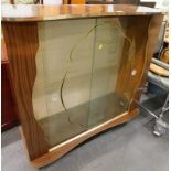A 1960s melamine display cabinet, with glass sliding doors and shelves, 103cm wide.