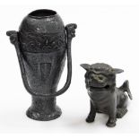 A bronze temple dog, with mouth open, raised on front paws, 14cm high, a vase of tapering circular