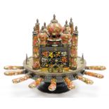 An Indian painted toasting machine, in the form of the Taj Mahal with various knives and forks