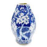 A Chinese porcelain baluster vase of octagonal section, profusely decorated with prunus flowers on a