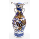 A Japanese porcelain blue and white vase, with flared neck and ear handles decorated with flowers