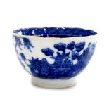 A Chinese export porcelain blue and white tea bowl, decorated with buildings, birds and trees with
