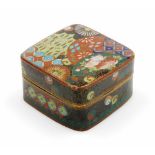 A 20thC Japanese cloisonne box and cover, profusely decorated with flowers in orange, blue, black