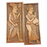 Two 20thC African tribal carved panels, the first figure in flowing robes holding vessel, the