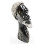 Tribal art. A carved stone figure of a bearded gentleman, 24cm high.