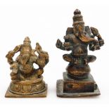 An Indian Hindu bronze figure of Ganesh, modelled seated with four arms holding various symbols,