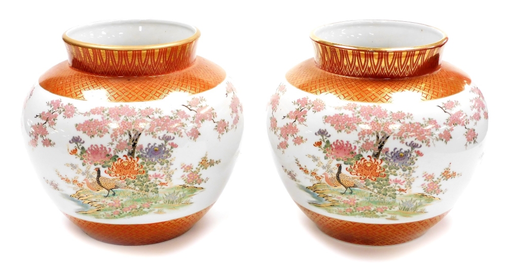 A pair of Japanese Kutani porcelain jardinieres, decorated with pheasants chrysanthemums and