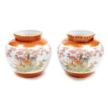 A pair of Japanese Kutani porcelain jardinieres, decorated with pheasants chrysanthemums and
