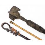A heavily carved African staff, partially ebonised, with turned handle and elaborate top, 106cm