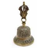 An Indian brass Hindu temple prayer bell, the handle of cast crown and deity mask form, 19cm high.