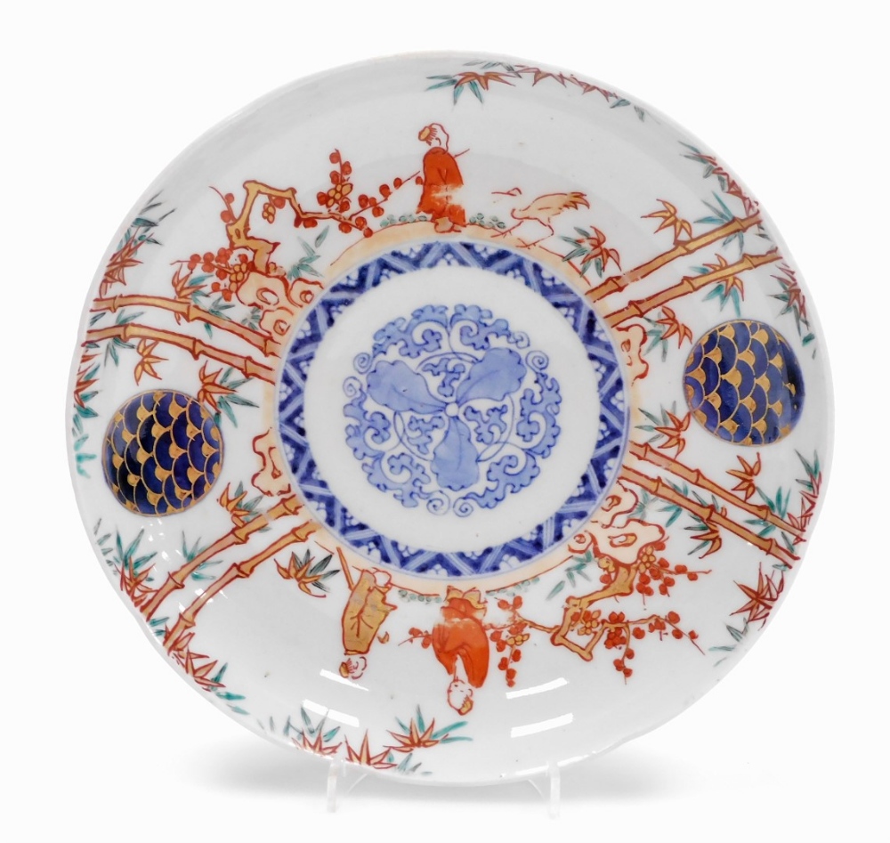 A set of four Japanese Imari porcelain plates, decorated with figures among bamboo and prunus, - Image 6 of 9