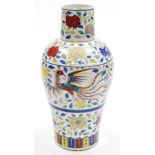 A Chinese porcelain baluster vase with tall neck, enamelled with bands of scrolling peonies and ho-o