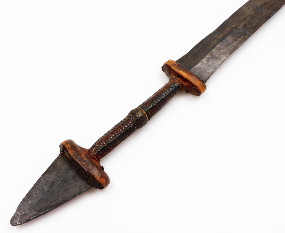 An African tribal knife, with tapering blade, turned handle with metal arrowhead pommel, 68cm wide. - Image 3 of 5