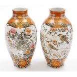 A pair of Japanese Kutani vases, of ovoid form decorated with panels of birds and flowers,