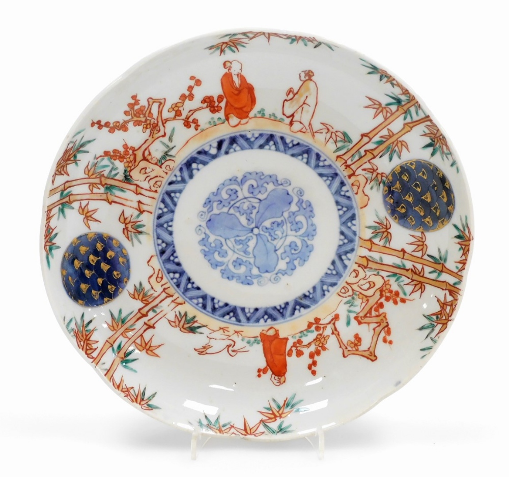 A set of four Japanese Imari porcelain plates, decorated with figures among bamboo and prunus, - Image 2 of 9