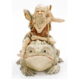 An unusual Japanese Satsuma group of a Gama Sennin seated upon his giant toad, Meiji period. 28cm