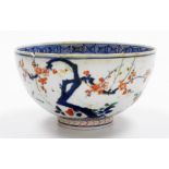 A Japanese Imari porcelain bowl, with an inner Greek keyfret border with peony to the centre,